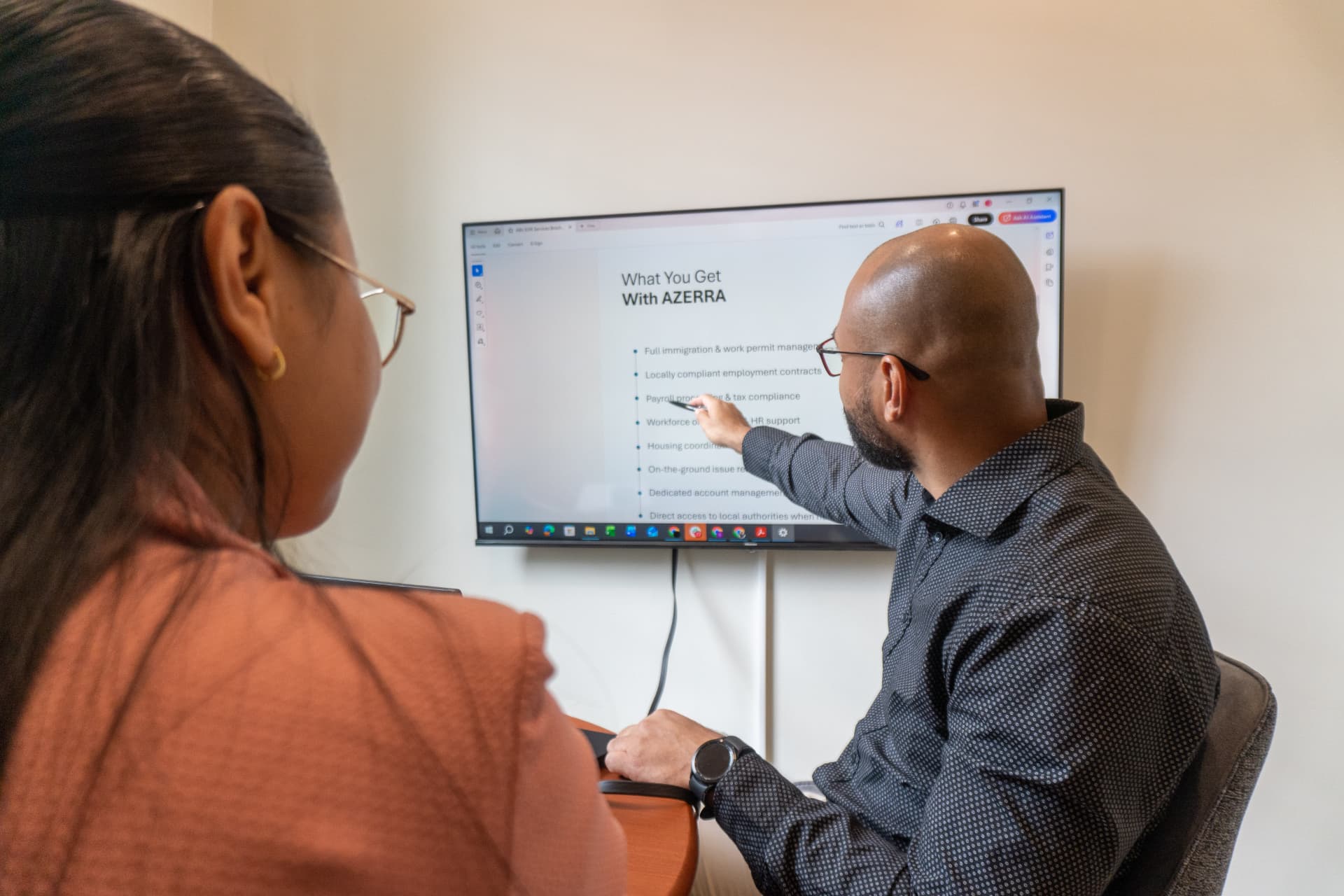 AZERRA advisors reviewing the EOR service scope on screen at the Paramaribo office